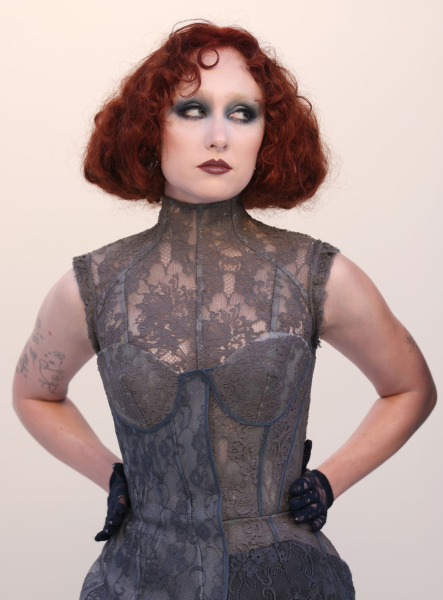 Chappell Roan posses in a gray lacy dress